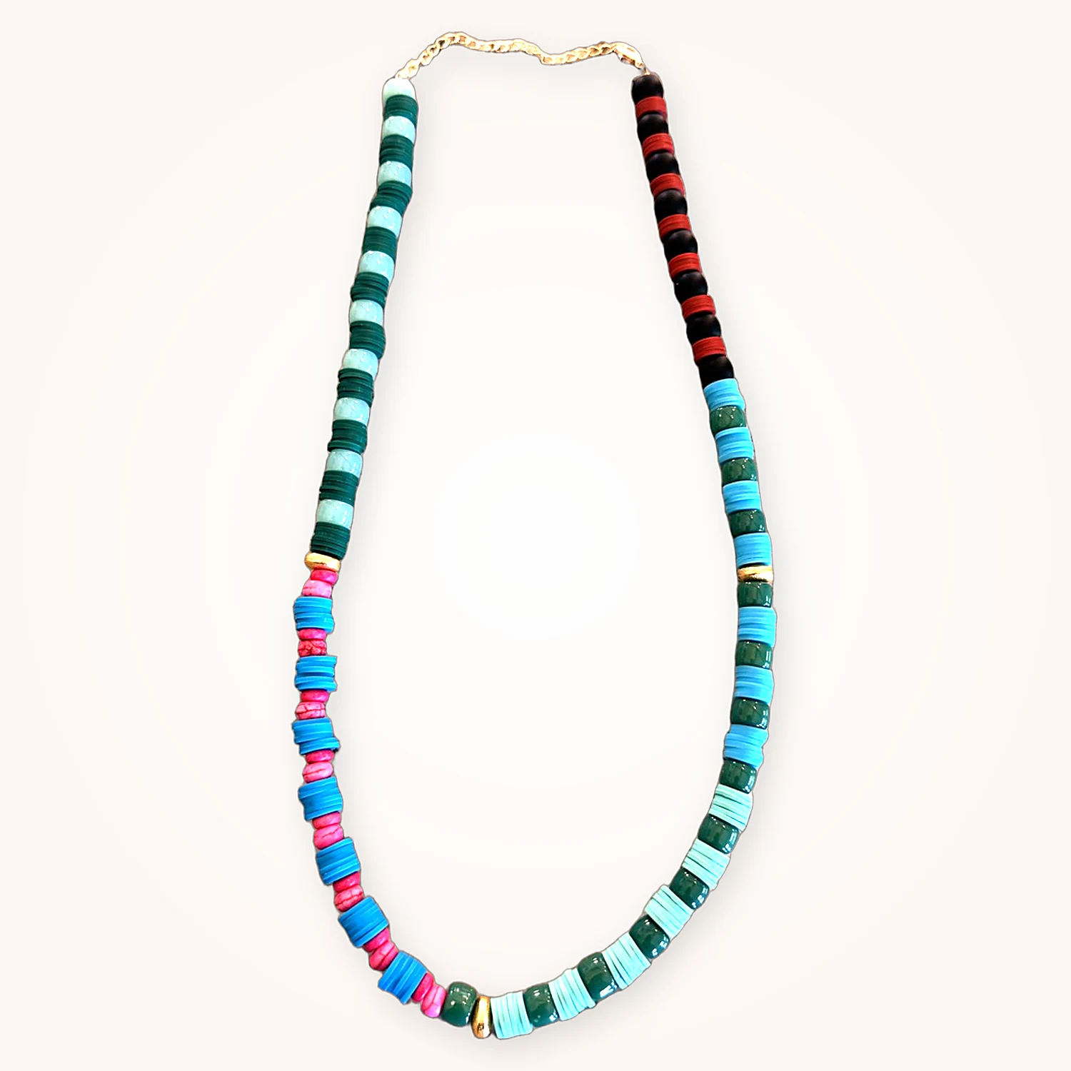 A heishi disc necklace in turquoise, teal, pink and red, with gold spacers
